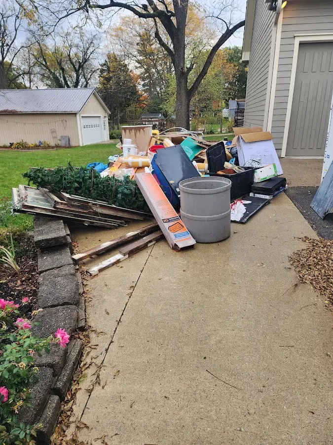 Dumpster being loaded with debris for Roofing Dumpster Rental in Aubrey